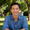 Portrait of David Kim smiling outdoors in natural light